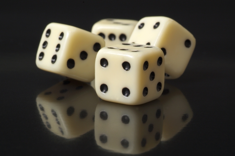 541493-white-dice-on-a-black-background